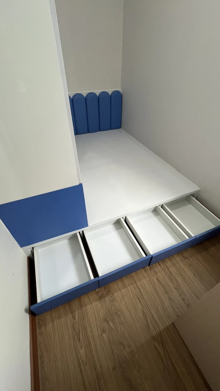 Detail meja atau kabinet putih dengan laci tarik.